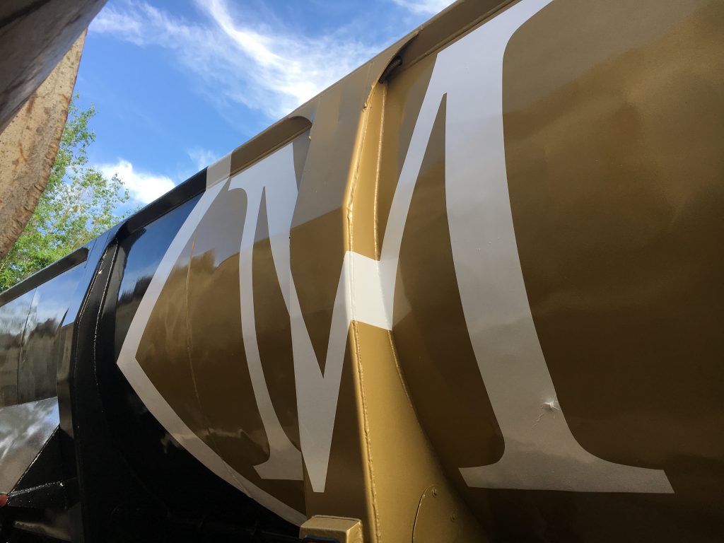 Large metal equipment with M in gold or white paint