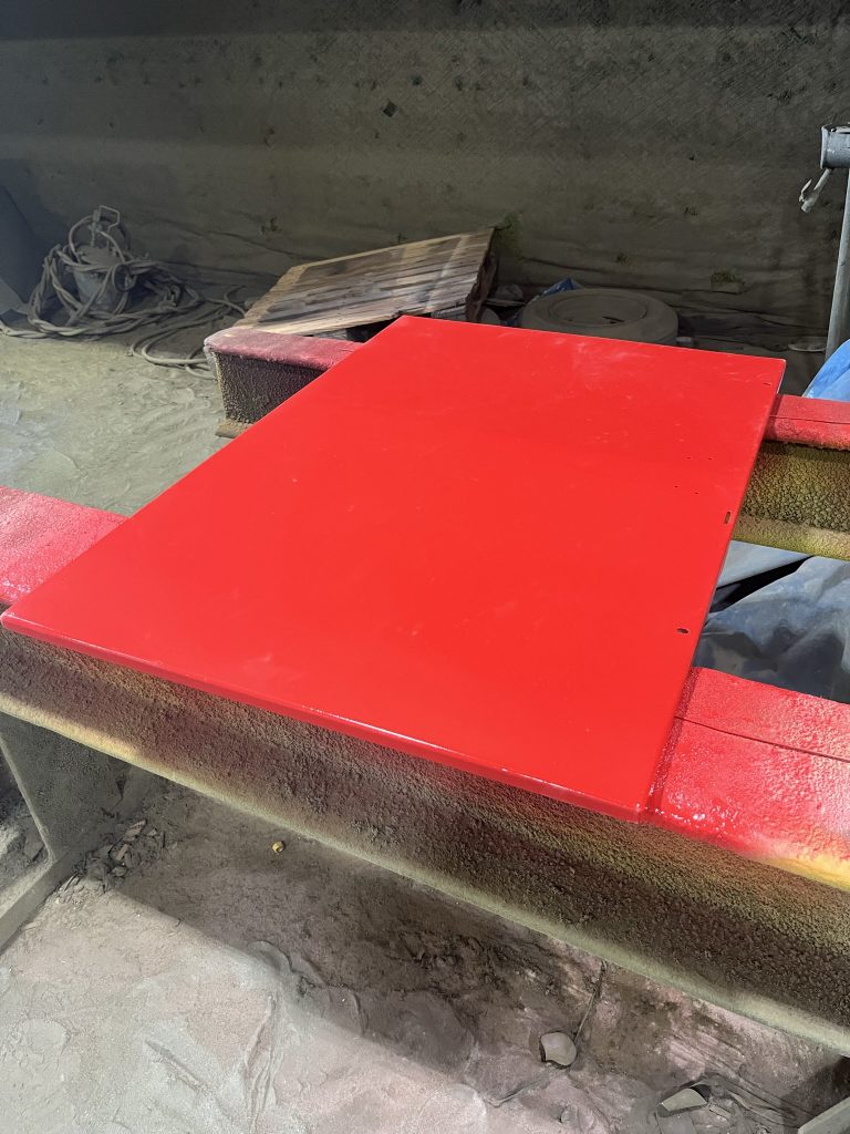 Red painted flat metal rectangle