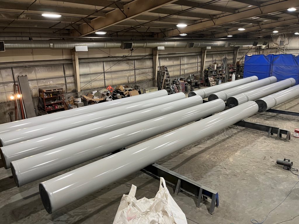 Gray pipes from above in painting facility